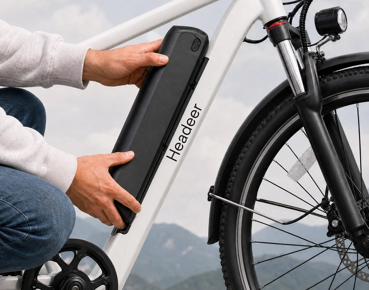 Hands demonstrating the removable 648Wh lithium-ion electric bike battery on an EAZION BK1350